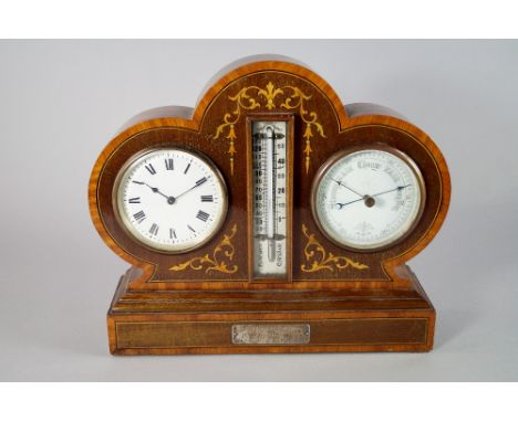 An Edwardian mahogany and inlaid clock/barometer, the case of clover leaf outline, decorated with line inlaid and tendril dec