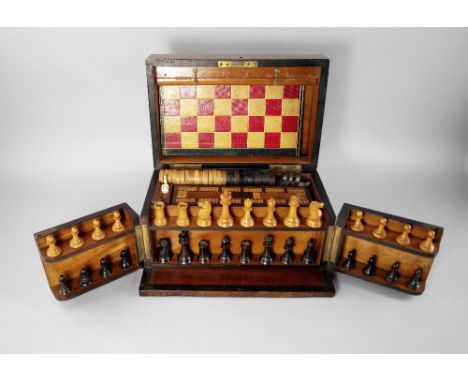 A Victorian walnut games compendium, 19th century, to contain chess set, draughts men, board and other pieces, 32cm wide COND