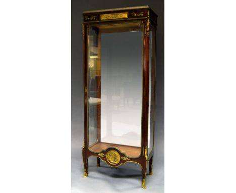 A French mahogany ormolu vitrine, 19th century, with white marble top above a clear glazed body with single door, decorated w