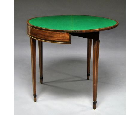 A George III mahogany fold over card table, raised on tapering legs, 76cm high x 88cm wide. 