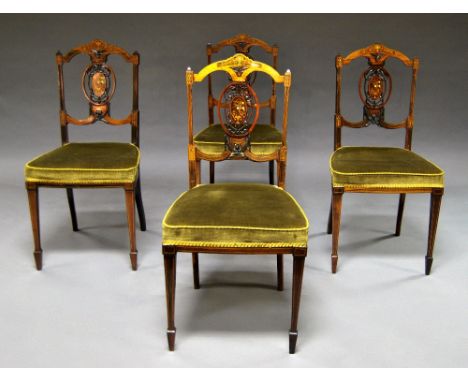 A set of four Edwardian mahogany inlaid chairs, early 20th century, the splat inlaid with floral motifs, raised on spade legs