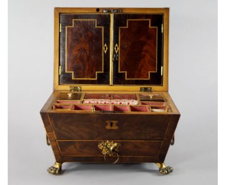 An English mahogany and rosewood banded sarcophagus form needlework box, late 18th/early 19th century,  with lions mask handl
