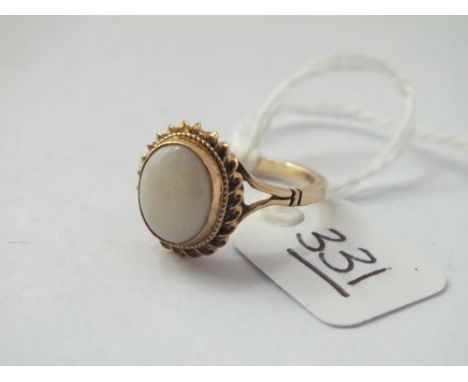 A oval opal ring set in 9ct - size M - 2.4gms