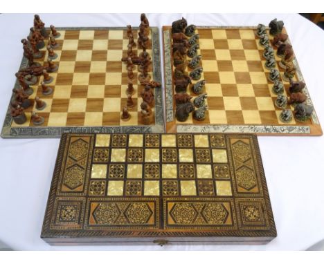 AFRICAN THEMED CHESS BOARDthe sides with panels of animals, the playing pieces represented by resin animals, together with a 