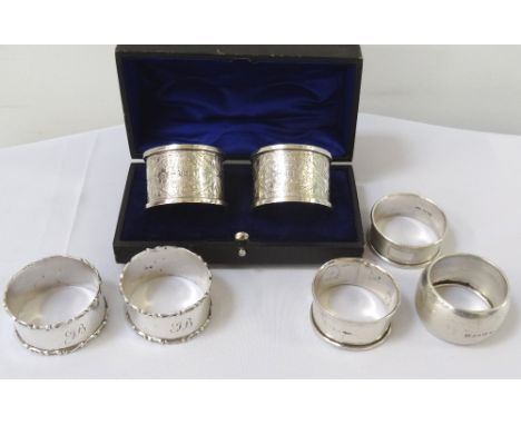 PAIR OF EDWARD VII SILVER NAPKIN RINGSeach with chased decoration, Birmingham 1908 by John Rose in a fitted case; together wi