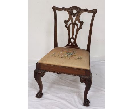 LATE VICTORIAN CHIPPENDALE STYLE MAHOGANY DINING CHAIRwith carved backrest, embroidered drop-in seat pad, raised on front leg