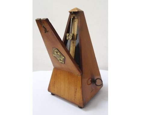 FRENCH METRONOMEwith a shaped impressed brass plaque to the lid and paper scale to the interior, 22cm high 