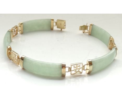 JADE AND NINE CARAT GOLD BRACELETwith alternating jade panels and pierced gold squares with character decoration, with safety