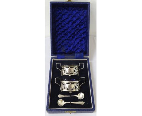 PAIR OF EDWARD VII SILVER SALTSeach with pierced decoration and a central shield flanked by a pair of shaped handles, raised 