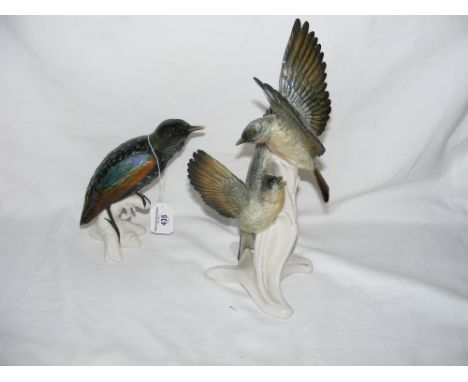A continental ceramic bird ornament and one other