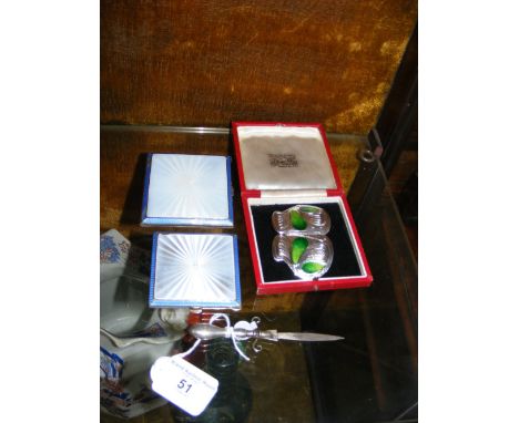 A silver and enamel compact, belt buckle, etc