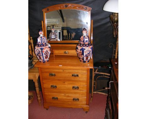 An Edwardian dressing table with carved Art Nouveau style mirror surround 