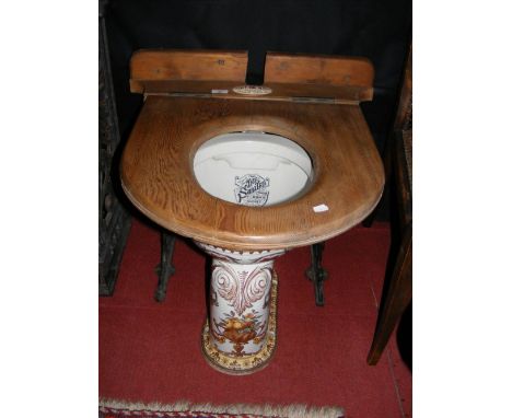 A Victorian transfer printed ceramic toilet - "The Sanitas" - with pine surround