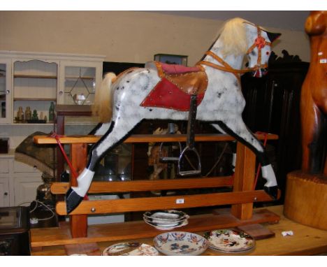 A 110cm high painted wooden rocking horse 