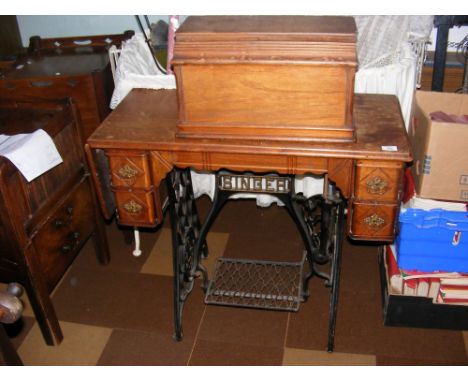 A treadle Singer sewing machine in fitted surround