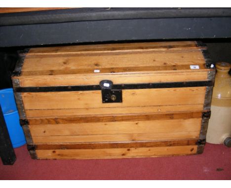 An antique dome top travelling trunk