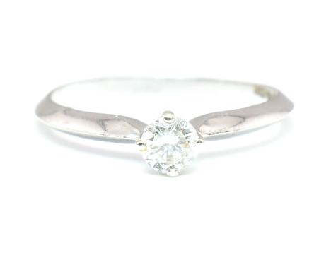 A hallmarked 9ct white gold and diamond solitaire ring. The 9ct white gold ring set with a single round brilliant cut diamond