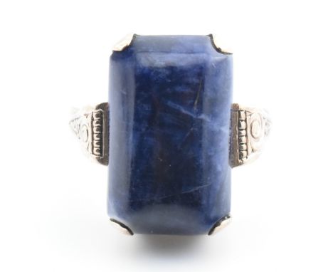 An 8ct gold and sodalite ring. The 8ct yellow gold ring set with a rectangular sodalite cabochon set in an engraved mount wit
