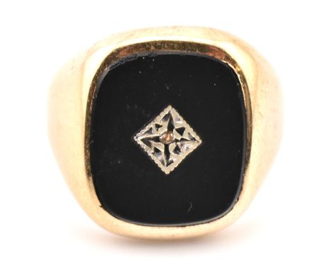A hallmarked 9ct gold onyx and diamond signet ring. The 9ct yellow gold signet ring having a rectangular face set with onyx h