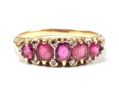 A gold, red stone and diamond five stone ring. The ring having a mixture of mixed cut red stones including ruby interspersed 