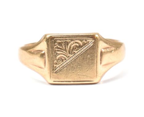 A hallmarked 9ct gold signet ring. The 9ct yellow signet ring having a squared head, half decorated with bright cut engraving
