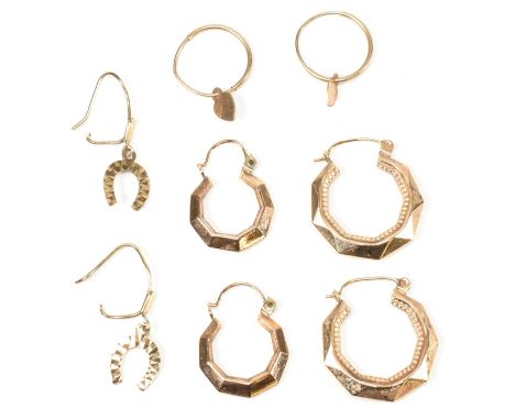 A collection of 9ct gold earrings. The earrings to include two pairs of faceted 9ct gold hoop earrings, horseshoe pendant ear