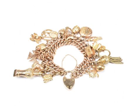 A hallmarked 9ct gold charm bracelet with heart padlock clasp. The hallmarked 9ct gold double strand curb link bracelet strun