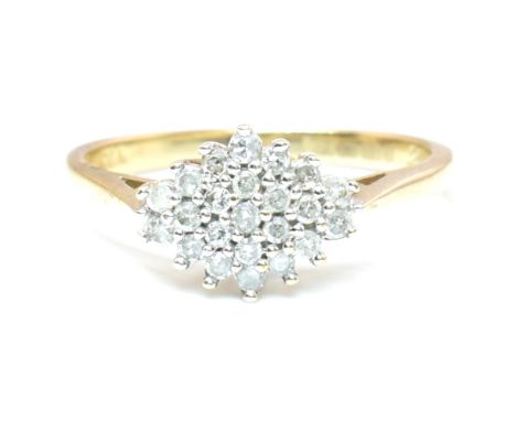 A hallmarked 9ct gold and diamond cluster ring. The 9ct yellow gold ring having twenty-three shared claw set round cut diamon