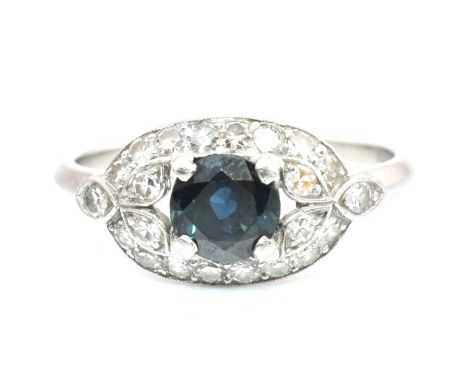 Edwardian sapphire and diamond ring.&nbsp;The antique ring set with a round cut sapphire framed by a pierced diamond set foli