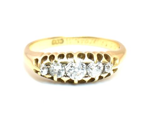 An 18ct gold and diamond five stone ring. The 18ct yellow gold ring set with a single row of five old cut diamonds set in a p