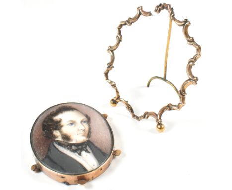 A 19th century portrait miniature together with a rolled gold easel stand. The lot to include an oval portrait miniature of a