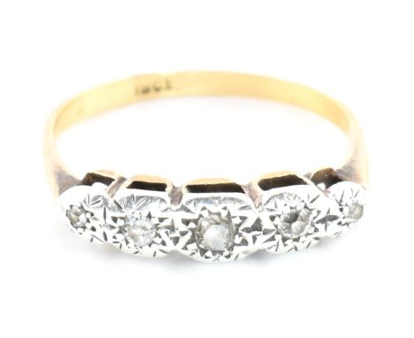 A 18ct gold and diamond five stone ring. The 18ct ring set having five graduating illusion set diamonds set in a white gold s