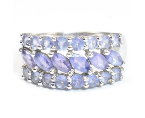 A hallmarked 9ct white gold and purple stone cluster ring. The ring having central row of six marquise cut purple stones flan