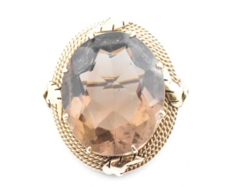 A yellow tone metal and smoky quartz necklace pendant. The pendant having with a single claw set oval cut smoky quartz set in
