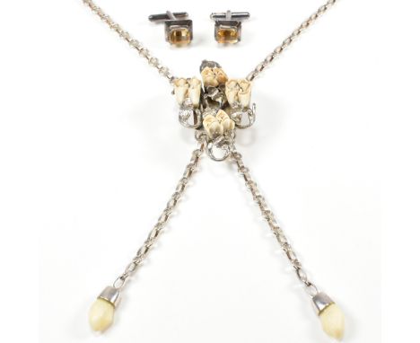 Vintage hunting bolo tie necklace set with animal teeth. The Jagdschmuck hirschgrandln necklace having a silver pendant set w