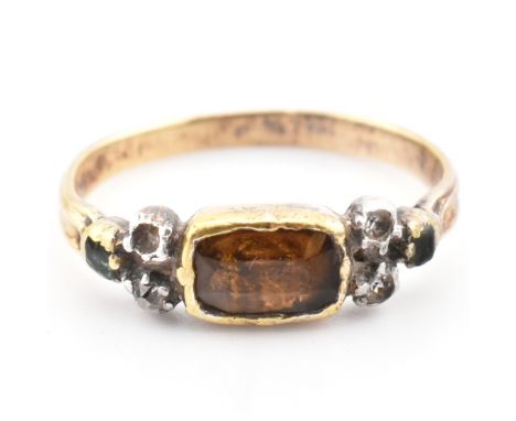 A 19th century gold and silver gem set ring. The ring set with a bezel set citrine flanked by diamond, emerald and white ston
