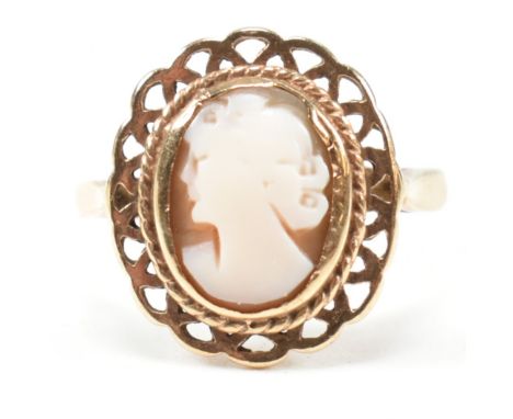 A hallmarked 9ct gold and carved shell cameo ring. The ring having a bezel set carved shell cameo depicting the profile of a 