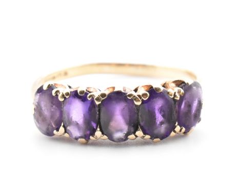 A hallmarked 9ct gold and amethyst five stone ring. The ring set with a single row of five shared claw set oval cut amethysts