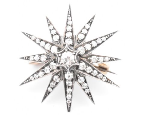A Victorian gold and silver diamond star brooch pin. The 19th century twelve-pointed star brooch pin set with forty-nine old 