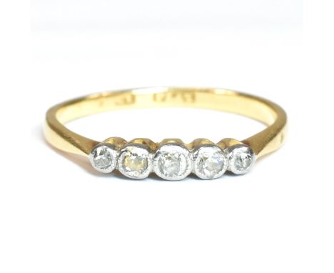 An 18ct gold, platinum and diamond five stone ring. The ring having five graduating bezel set round cut diamonds set in a pla