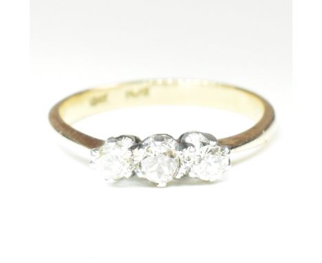 An 18ct gold, platinum and diamond trilogy ring. The ring having three shared claw set round cut diamonds set in a platinum m