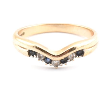A hallmarked 9ct gold, diamond and sapphire wishbone ring. The 9ct yellow gold ring set with a single row of four round cut s