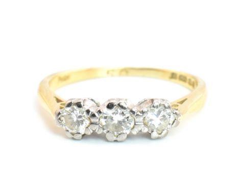 A hallmarked 18ct gold and diamond trilogy ring. The 18ct yellow gold ring having three graduating double claw set round cut 