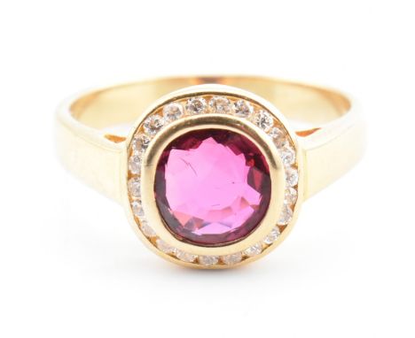 An 18ct gold, ruby and diamond cluster ring with certificate. The 18ct yellow gold cluster ring having a bezel set cushion cu