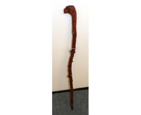 An unusual carved walking stick in the form of heads bearing date 1851