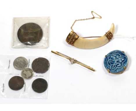 An opal bar brooch, length 6.3cm; a wild boar tusk brooch, mounted in 15 carat gold; a pottery seal brooch; coins etc 