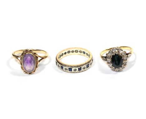 A cluster ring, stamped '18CT', finger size O1/2; an amethyst ring, stamped '9CT', finger size P1/2; and a 9 carat white gold