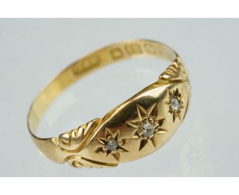 Late Victorian diamond 18ct yellow gold three stone ring, three small rose cut diamonds, gypsy set, engraved scroll design sh