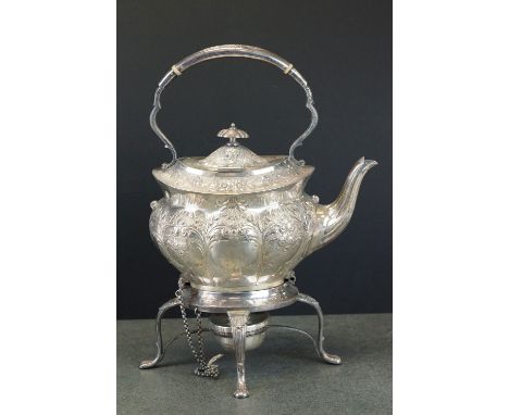 Edwardian silver spirit kettle, the teapot with repoussé floral and foliate decoration throughout, hinged lid; the stand with