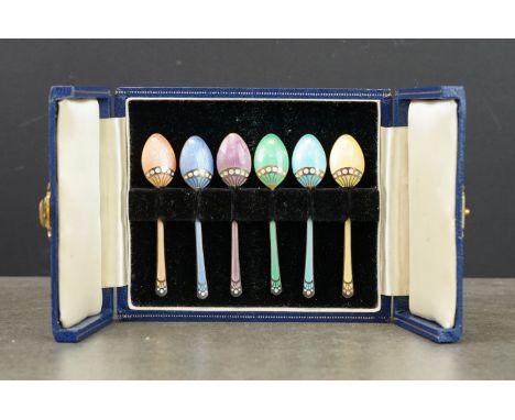 Six harlequin enamelled silver demitasse spoons, the bowl reverse and terminal with silver inlaid decoration and white enamel